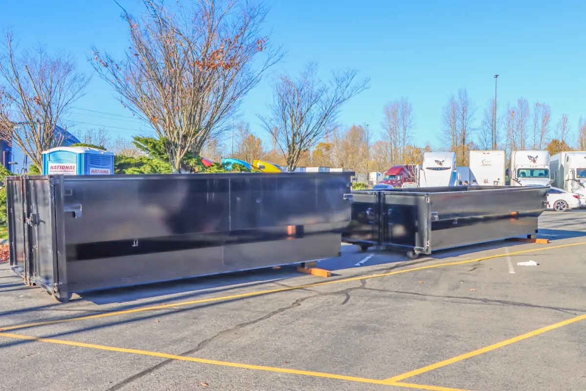 Professional dumpster rental service with roll-off container on residential driveway in Asbury Park